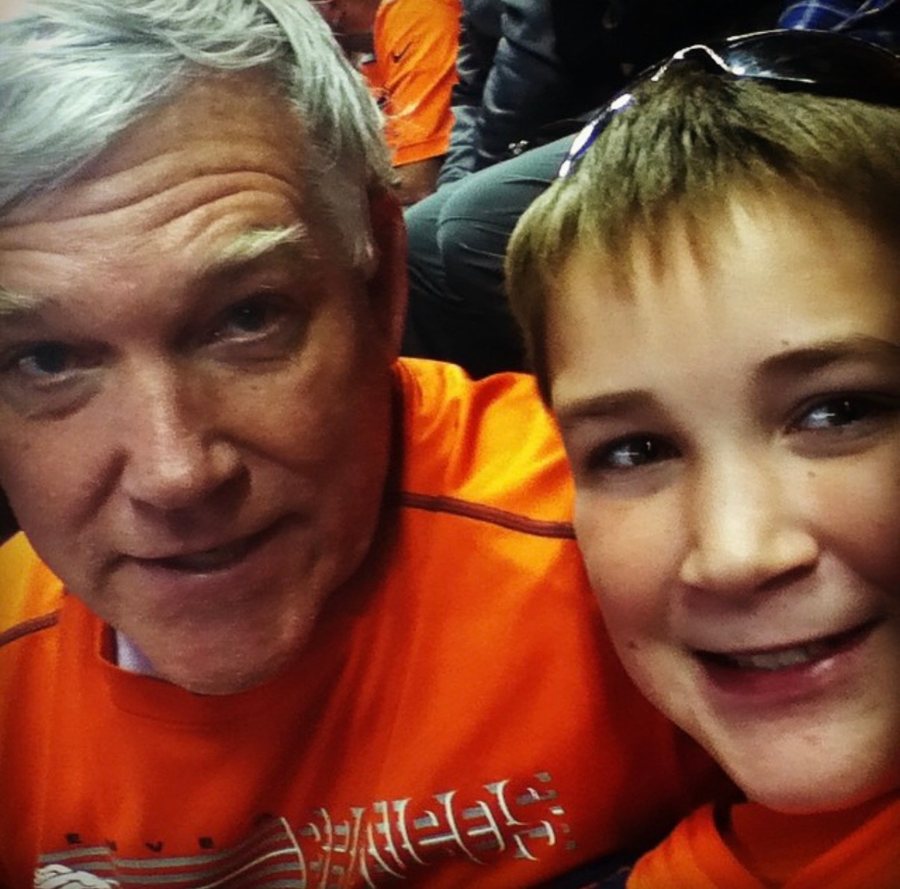 Alex and his godfather in orange at the Denver Broncos game