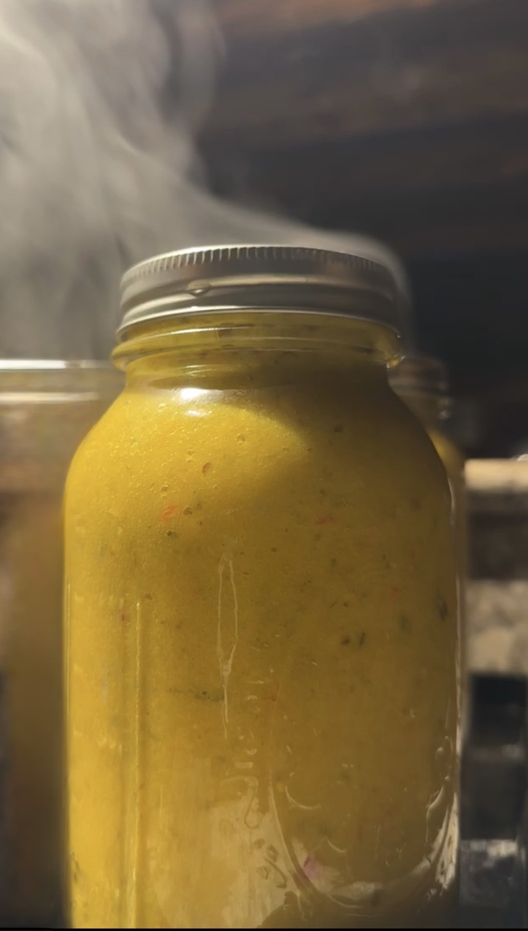 A jar of fresh mustard steaming