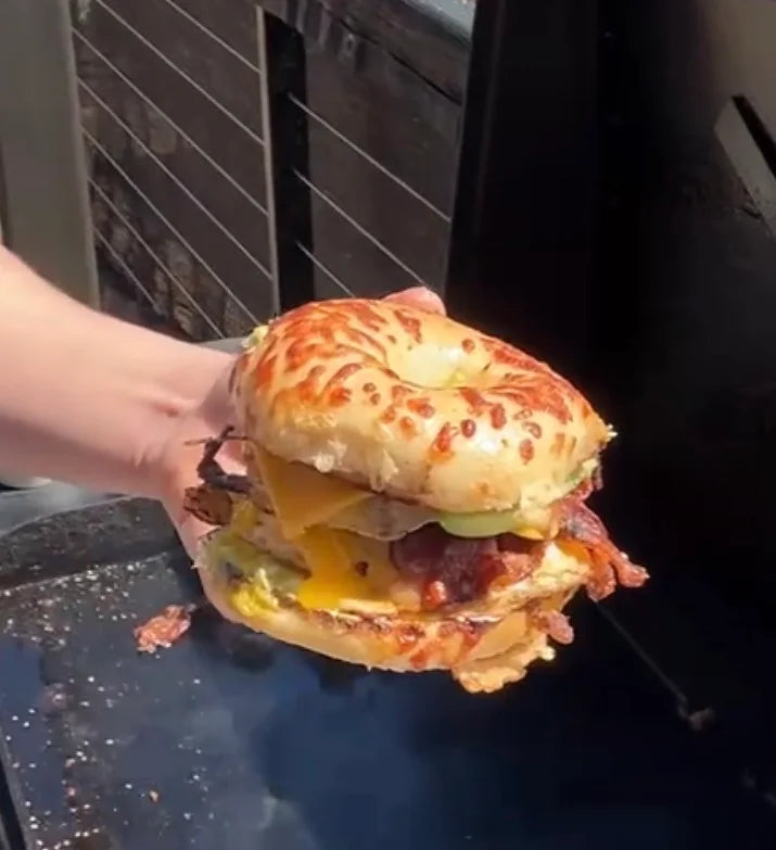 The BAHM BEC from the video: a cheese-topped bagel stacked with bacon, egg and melted cheese