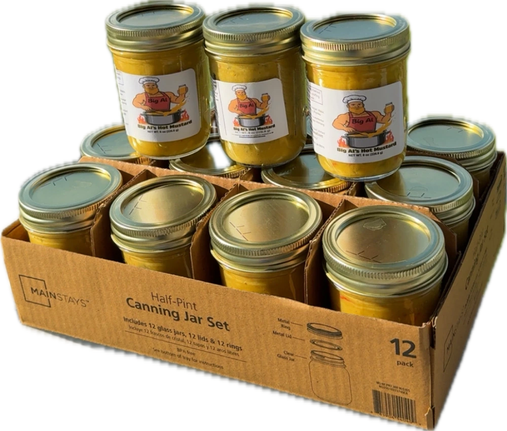 Hand-jarred Big Al's Hot Mustard jars stacked on a box of canning jars